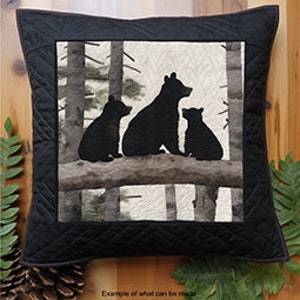 May include: A black and white quilt pattern featuring three black bear cubs sitting on a branch in a forest setting. The pattern is for a quilt or pillow and is part of the "Spindles and Quilts Sitting Bear Cubs Patterns" collection.