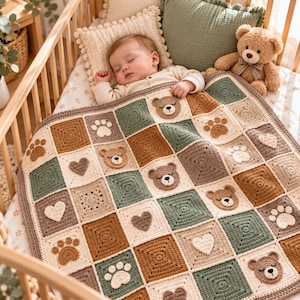 May include: A crochet baby blanket featuring a patchwork design of squares in shades of sage green, cream, and brown. The blanket is decorated with appliqued motifs including sleeping bear faces, paw prints, and hearts in matching colours.
