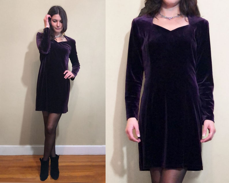 May include: A purple velvet dress with a scoop neck and long sleeves.