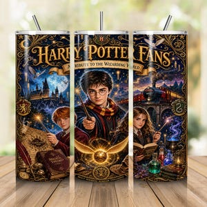 May include: A cylindrical tumbler with a straw featuring a dark blue and gold Harry Potter theme. The design displays characters, a castle, a steam train, and magical items. Text reads Harry Potter Fans A Tribute To The Wizarding World.