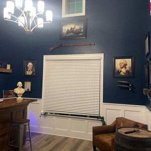 a living room with blue walls and a white window