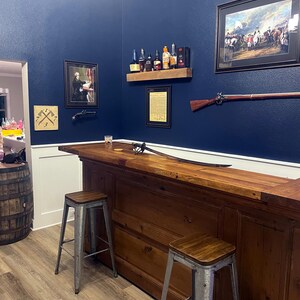 a bar with two stools in a room
