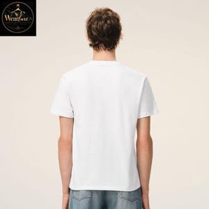 May include: A plain white short-sleeved t-shirt worn with blue denim jeans. The t-shirt features a simple crew neckline and a standard fit, shown from the back view. The fabric appears smooth and opaque, providing a clean and neutral appearance.