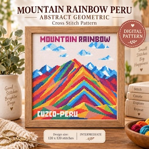 Op de afbeelding: Een vierkant kruissteekpatroon in een houten lijst met een kleurrijk gebergte met regenboogstrepen, blauwe toppen en wolken. De tekst luidt MOUNTAIN RAINBOW en CUZCO-PERU. De ontwerpmaat is 120 x 120 steken, aangeduid als gemiddeld niveau.
