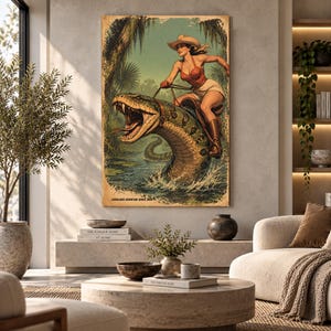 May include: A rectangular wall art print featuring a vintage-style illustration of a person in a cowboy hat, red top, and shorts riding a large, open-mouthed snake through a swamp. The text at the bottom reads Everglades Adventure Series Book 1.