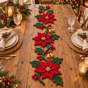 May include: A crocheted Christmas table runner featuring three large red poinsettia flowers with gold bead centers, green holly leaves, clusters of red berries, and pairs of small gold bells connected by red yarn bows along a central vine.