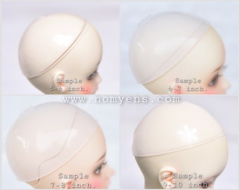 May include: Four doll heads with different sized wig caps. The caps are translucent and cover the doll's head. The sizes are labeled as 5-6 inch, 6-7 inch, 7-8 inch, and 9-10 inch. The website www.nomyens.com is also visible.