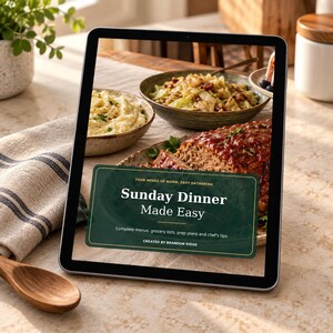 Könnte beinhalten: Ein digitales Tablet zeigt das Cover eines Kochbuchs mit dem Titel Sunday Dinner Made Easy, mit einem dunkelgrünen rechteckigen Overlay und weißem Text, das ein Gericht aus Hackbraten, Kartoffelbrei und Kohl auf einem Küchentisch zeigt.
