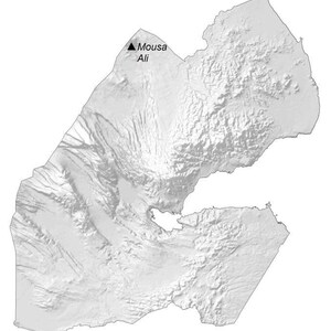 May include: A greyscale relief map of the country of Djibouti, showing its varied topography and coastline. A black triangle symbol marks the location of Mousa Ali, with the text "Mousa Ali" printed clearly next to the mountain peak marker.