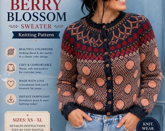 May include: A long-sleeve button-up cardigan jumper featuring a dark navy blue base with a multi-coloured yoke pattern of red and pink floral motifs, and a body pattern of large pink polka dots. The jumper has a round neckline and dark buttons.