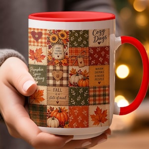 May include: A white ceramic mug with a bright red rim and handle, featuring a patchwork-style design of autumn-themed squares. The pattern includes pumpkins, maple leaves, sunflowers, and text that reads Cozy Days, Pumpkin Spice everything, and Fall is a state of mind.