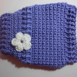 May include: A purple crocheted vest with a white crocheted flower.