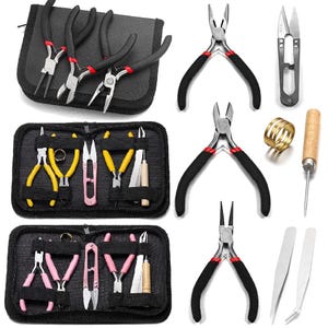 May include: A jewelry making tool set featuring various pliers with black, yellow, and pink handles, metal snips, tweezers, a wooden handled awl, a brass ring, and three black zippered storage cases with elastic loops for organizing the tools.