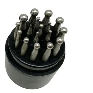 May include: A set of silver-colored metal ball stylus tools arranged in a circular black holder. The tools feature varying sizes of spherical tips attached to tapered shafts, designed for precision work, and are organized upright in the base.