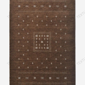 May include: A rectangular area rug in a deep brown tone featuring a repeating pattern of small white diamonds and square dot clusters. The design includes horizontal bands of white geometric symbols across the top and bottom sections.