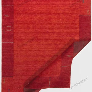 May include: A rectangular area rug featuring a vibrant red center with a darker red border. The rug displays subtle, small embroidered geometric patterns and thin lines in muted tones scattered across the surface. The text TEXTURAKNOT is visible.