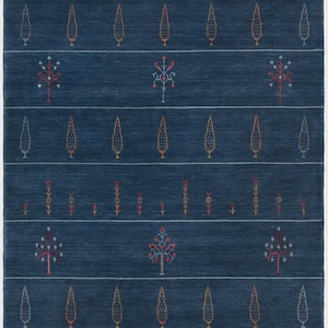 May include: A rectangular area rug in deep navy blue featuring horizontal rows of embroidered motifs. The design includes alternating bands of small vertical floral stems and stylized evergreen trees in shades of orange, white, and red.