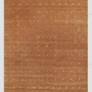 May include: A rectangular area rug in a solid terracotta brown color featuring a central square motif and a surrounding rectangular border, both composed of small, light-colored geometric diamond and dot patterns woven into the fabric.