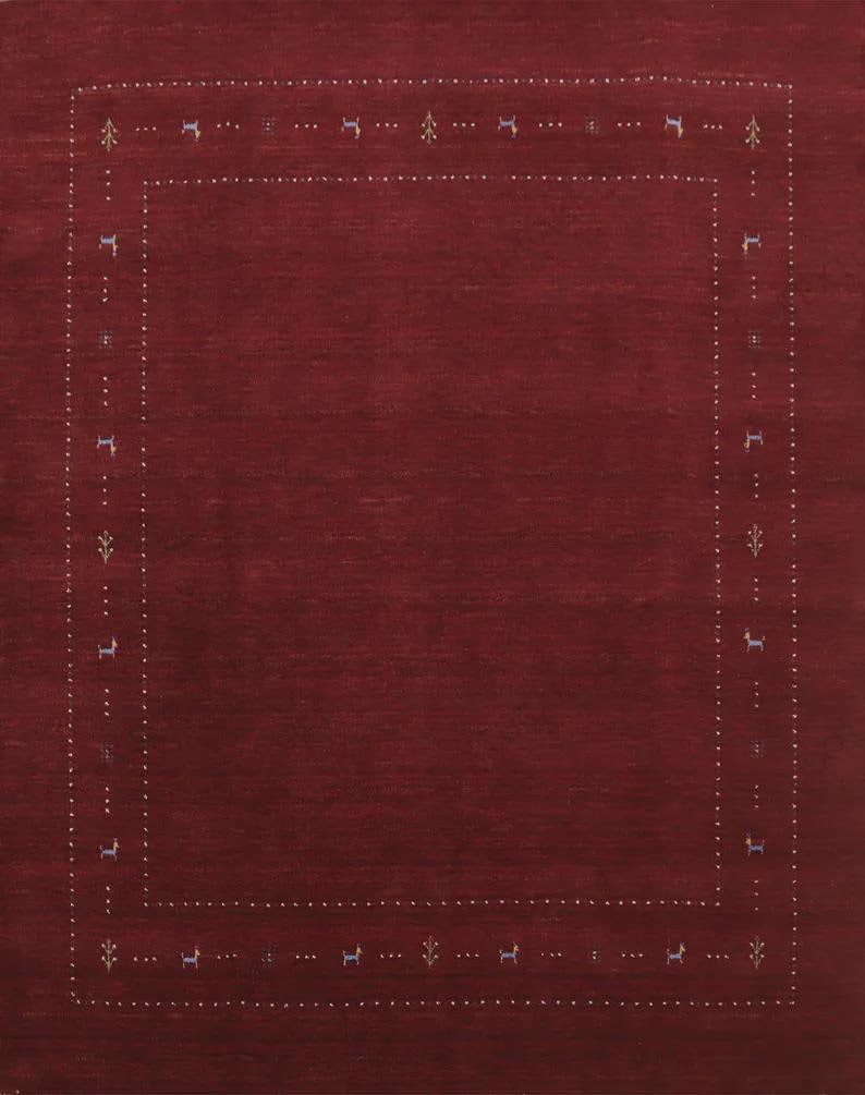 May include: A deep burgundy rectangular area rug featuring a central solid field surrounded by a decorative border. The border consists of two parallel lines of small white dots interspersed with tiny stylized animal and floral motifs.