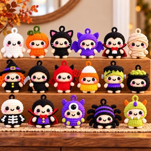 May include: A collection of seventeen small, crocheted Halloween-themed ornaments arranged on a wooden tiered stand. The figures include a ghost, pumpkin, cat, bat, vampire, mummy, witch, reaper, devil, candy corn, Frankenstein, cauldron, skeleton, and spider.