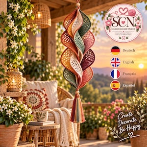 May include: A hanging spiral crochet wind spinner featuring layers of mustard yellow, cream, sage green, and deep burgundy yarn. The ornament is finished with a multi-colored tassel at the bottom and a wooden bead at the top for suspension.