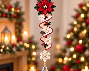 May include: A hanging Christmas ornament featuring a red crocheted poinsettia flower at the top, followed by a spiraling white ribbon accented with small white crocheted snowflakes, red berries, and a large white snowflake at the bottom with a crystal.