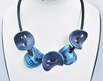 2 color blue button like  beads necklace/ 2 sides bright and dark blue Fimo on a 5 mm. rubber cord/ many possibilities to vary.