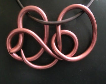 Red (pink) metallic snake necklace/ polymer art with red metal powder/ coiled serpent hanging in loops on a rubber cord