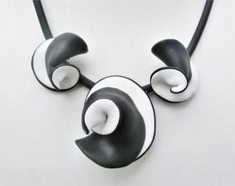 Black and white unique necklace/ brooch and ear clips/ wavy polymer clay combination on a 5 mm. rubber neck wire/  3 parts/ matching ring