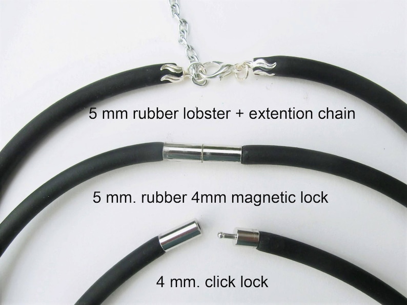 May include: Three black rubber necklace cords with different clasps. The top cord has a silver lobster clasp with an extension chain. The middle cord has a silver magnetic clasp. The bottom cord has a silver click clasp. The cords are labeled with their size and clasp type.