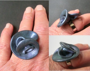 big swirly metallic blue ring with adjustable metal band/ polymer clay with blue metal powder with a purple and geen shine/ nice flat shape