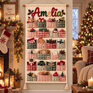 May include: A fabric Christmas advent calendar hanging on a wall, featuring the name Amelia in red and green yarn at the top. It has twenty-four pockets with red and green stripes, each numbered one through twenty-four, containing small holiday items.