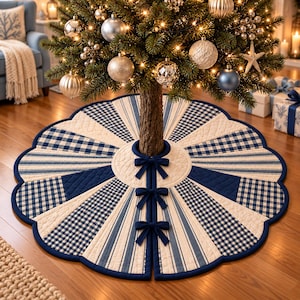May include: A circular quilted Christmas tree skirt featuring a scalloped edge and a pattern of alternating navy blue and white gingham check panels and cream-colored striped sections. The skirt includes three navy blue fabric bows for closure.
