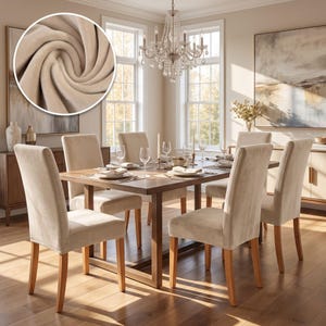 May include: A dining set featuring a rectangular wooden table and six chairs upholstered in a light beige fabric. The chairs have wooden legs and a smooth, soft-textured surface. The table is set with white plates, glasses, and napkins.