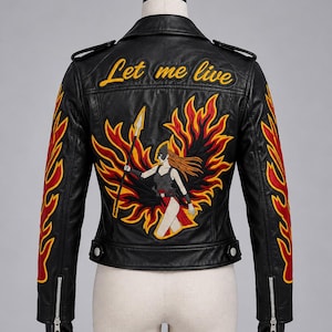 May include: A black leather motorcycle jacket featuring a large embroidered back patch of a warrior figure with a spear surrounded by red and yellow flames. The text Let me live is embroidered in yellow above the figure, with flame patterns on sleeves.