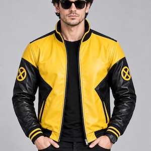 May include: A yellow and black leather bomber jacket featuring a high collar, a full-length front zipper, and black sleeves with a circular yellow and black X-shaped emblem on each shoulder. The jacket includes black ribbed cuffs and a black hem.