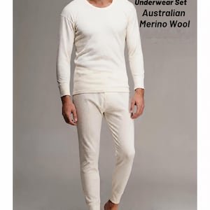 May include: A cream-colored thermal underwear set made of Australian Merino wool, consisting of a long-sleeved crew neck top and matching long pants. The text "Wool Thermal Underwear Set Australian Merino Wool" is printed on the right side.