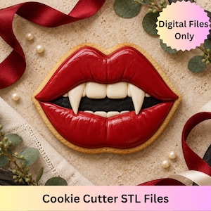 May include: A cookie shaped like a pair of red lips with white fangs and a black mouth interior. The image includes text that reads Digital Files Only and Cookie Cutter STL Files. The cookie is decorated with glossy red icing.