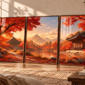 May include: A triptych wall art set featuring a continuous landscape scene with vibrant red autumn foliage, traditional East Asian architecture, a calm lake, and distant mountains under a soft golden sunset sky, all framed in thin dark wood.