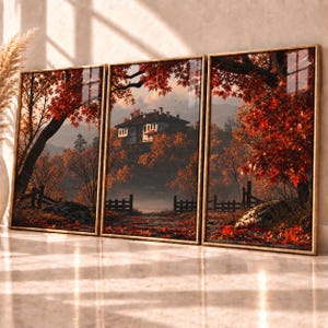 May include: A triptych wall art set featuring a landscape with a house nestled among trees with vibrant red autumn leaves. The scene includes a stone path, a wooden fence, and fallen red foliage on the ground, framed in thin gold metal borders.