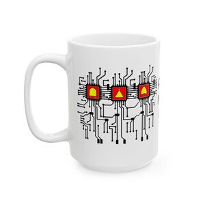 May include: A white ceramic mug featuring a black printed circuit board pattern with three red square microchips. Each chip contains a yellow logic gate symbol, specifically an AND, NOT, and OR gate, connected by intricate black circuit lines.