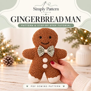 May include: A brown textured gingerbread man plush toy featuring a green and white gingham bow tie, two white circular buttons on the chest, and white icing-like accents on the feet. The text reads Simply Pattern Studio GINGERBREAD MAN.
