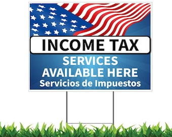 May include: A blue and white sign with an American flag in the background. The sign says "Income Tax Services Available Here" and "Servicios de Impuestos" in Spanish.
