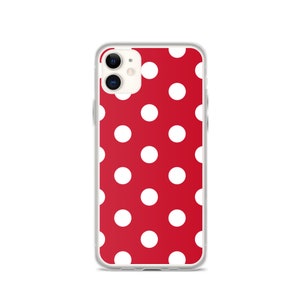 May include: A clear phone case with a red background and white polka dots.