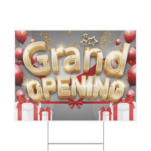 May include: A gray and red grand opening sign with gold lettering and red and gold balloons. The sign says "Grand Opening" in large, bold, gold letters.