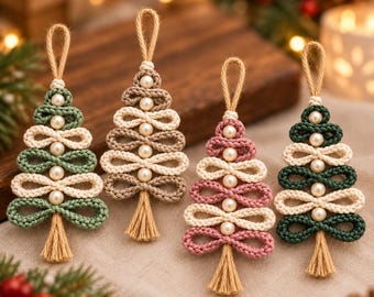 May include: Four handmade macrame Christmas tree ornaments featuring looped cord in sage green, beige, dusty pink, and dark forest green. Each tree is accented with white faux pearls, a jute hanging loop at the top, and a small tan tassel at the base.