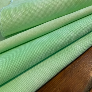 Cross stitch Hand dyed Aida in 14, 16 and 18 counts. And 32 count Murano. Spring green.