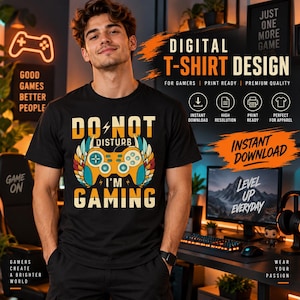 May include: A black short-sleeved t-shirt featuring a graphic of a yellow and blue game controller with wings, surrounded by the text DO NOT DISTURB I'M GAMING in a bold, retro-style font. The design is centered on the chest of the garment.