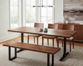 May include: A rectangular wooden dining table with a natural grain finish and black metal U-shaped legs, accompanied by a matching wooden bench and three wooden chairs with light-colored upholstered seats, arranged in a dining room setting.