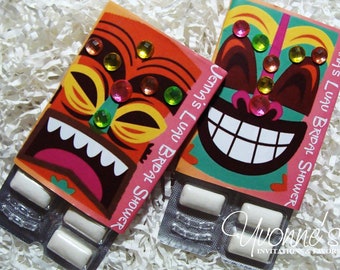 May include: Two packs of gum with colorful tiki mask designs. The text on the packs reads "Jenna's Luau Bridal Shower".